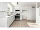Bright kitchen featuring stainless steel appliances, white cabinets, and tile flooring at 2508 N 58Th Ln, Phoenix, AZ 85035