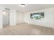 Living room featuring a large window, tile floors, and a doorway to the left at 2508 N 58Th Ln, Phoenix, AZ 85035
