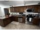 Well-equipped kitchen with stainless steel appliances, rich wood cabinetry, and granite countertops at 2726 W Butler Dr, Phoenix, AZ 85051