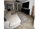 Spacious living room with tile flooring, a modern ceiling fan, and a comfortable sectional sofa at 2726 W Butler Dr, Phoenix, AZ 85051