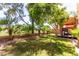 Lush backyard featuring a grilling area, mature trees, and well-maintained grass at 3041 E Fremont Rd, Phoenix, AZ 85042