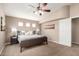 Bedroom featuring neutral walls, a ceiling fan, carpet flooring, and a modern bed frame with stylish bedside tables at 3041 E Fremont Rd, Phoenix, AZ 85042