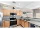 Well-equipped kitchen with stainless steel appliances, granite countertops, and light wood cabinetry at 3041 E Fremont Rd, Phoenix, AZ 85042
