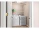 Functional laundry room features a washer, dryer, and shelving at 3041 E Fremont Rd, Phoenix, AZ 85042