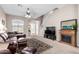 Bright living area showcasing a fireplace, large television, and staircase at 3041 E Fremont Rd, Phoenix, AZ 85042