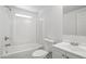 Bright all-white full bathroom with a shower-tub combo, a window, toilet and vanity at 320 E Mckellips Rd # 46, Mesa, AZ 85201