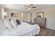 Well-lit bedroom featuring a large bed, dresser with mirror, and modern ceiling fan at 320 E Mckellips Rd # 46, Mesa, AZ 85201