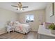 Light and bright bedroom with decor, a ceiling fan and a view of the community outside at 320 E Mckellips Rd # 46, Mesa, AZ 85201