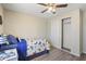 Bedroom with a ceiling fan, closet with sliding doors and blue twin bed with dinosaur comforter at 320 E Mckellips Rd # 46, Mesa, AZ 85201