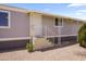 Exterior of a home with gray siding, white trim, desert landscaping and stairs to the front door at 320 E Mckellips Rd # 46, Mesa, AZ 85201
