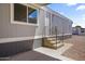 Exterior of a home with gray siding and a covered patio and stairs to the front door at 320 E Mckellips Rd # 46, Mesa, AZ 85201