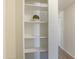 Floor-to-ceiling shelving providing storage with a decorative plant, and light tan walls at 320 E Mckellips Rd # 46, Mesa, AZ 85201