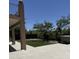 Backyard with artificial grass, desert landscape, and partially covered patio for comfortable outdoor living at 33220 N 60Th Way, Scottsdale, AZ 85266