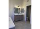 Bathroom featuring double vanity, tile floors, and a doorway to a toilet room at 33220 N 60Th Way, Scottsdale, AZ 85266