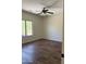 Bright bedroom with hardwood floors, ceiling fan, and a large window with outdoor view at 33220 N 60Th Way, Scottsdale, AZ 85266