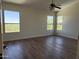 Bright bedroom featuring hardwood floors and natural light from multiple windows at 33220 N 60Th Way, Scottsdale, AZ 85266