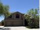 Charming two-story home with a three-car garage and desert landscaping is bathed in sunshine at 33220 N 60Th Way, Scottsdale, AZ 85266