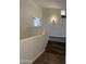 Hallway featuring wooden stairs, white walls, and view into the other rooms at 33220 N 60Th Way, Scottsdale, AZ 85266