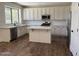 Modern kitchen featuring white cabinets, stainless steel appliances, white backsplash, and a kitchen island at 33220 N 60Th Way, Scottsdale, AZ 85266