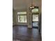 Inviting living room with wood floors, large windows, and a stylish chandelier by the front door at 33220 N 60Th Way, Scottsdale, AZ 85266
