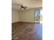 Open-concept living room with hardwood floors and sliding glass doors at 33220 N 60Th Way, Scottsdale, AZ 85266