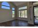 Bright living room with hardwood floors and multiple windows offering plenty of natural light at 33220 N 60Th Way, Scottsdale, AZ 85266