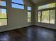 Bright living room with hardwood floors and multiple windows offering plenty of natural light at 33220 N 60Th Way, Scottsdale, AZ 85266