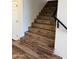 Staircase featuring hardwood steps and black railing at 33220 N 60Th Way, Scottsdale, AZ 85266