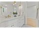 Bright bathroom featuring dual sinks, brass hardware, and a decorative black and white tiled floor at 3825 E Coolidge St, Phoenix, AZ 85018