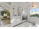 Elegant bathroom with marble floors, dual vanities, free-standing tub, and a separate glass-enclosed shower at 3825 E Coolidge St, Phoenix, AZ 85018