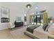 Bright bedroom boasts vaulted ceilings, seating area, and a large window overlooking the landscaped backyard at 3825 E Coolidge St, Phoenix, AZ 85018