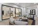An outdoor patio with cushioned seating and views to the interior living spaces through sliding glass doors at 3825 E Coolidge St, Phoenix, AZ 85018