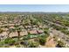 Aerial view of community with mature trees, pools, tile roofs and mountain views in the distance at 4010 E Hamblin Dr, Phoenix, AZ 85050
