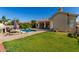 Spacious backyard with manicured lawn, swimming pool and covered patio offers a relaxing outdoor living space at 4010 E Hamblin Dr, Phoenix, AZ 85050