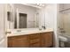 Bright bathroom featuring a double sink vanity with a large mirror and a separate toilet and tub area at 4010 E Hamblin Dr, Phoenix, AZ 85050
