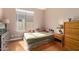 Cozy bedroom features a window, hardwood floors, and traditional furnishings at 4010 E Hamblin Dr, Phoenix, AZ 85050