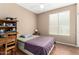 Comfortable bedroom featuring a window, hardwood floors, and traditional furnishings at 4010 E Hamblin Dr, Phoenix, AZ 85050