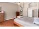 Spacious bedroom with high ceilings, hardwood floors, and a glimpse into the bathroom at 4010 E Hamblin Dr, Phoenix, AZ 85050