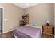 Comfortable bedroom featuring a window, hardwood floors, and traditional furnishings at 4010 E Hamblin Dr, Phoenix, AZ 85050