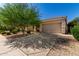 Inviting home features a mature tree, desert landscaping, and a spacious driveway at 4010 E Hamblin Dr, Phoenix, AZ 85050