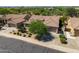 Landscaped front yard featuring mature trees, desert vegetation, and a welcoming driveway at 4010 E Hamblin Dr, Phoenix, AZ 85050