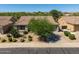 Charming home boasts a well-maintained front yard, a large tree and desert landscaping at 4010 E Hamblin Dr, Phoenix, AZ 85050