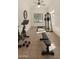 Home gym featuring stationary bicycle, weight bench, and weight machine with natural light from window at 4010 E Hamblin Dr, Phoenix, AZ 85050
