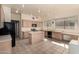 Spacious kitchen with wooden cabinets, an island, tile floor, and stainless steel appliances at 4010 E Hamblin Dr, Phoenix, AZ 85050