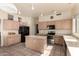 Bright kitchen featuring light wood cabinets, center island, tile floor, and stainless steel appliances at 4010 E Hamblin Dr, Phoenix, AZ 85050