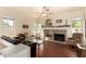 Bright living room with a tiled fireplace, ceiling fan, and hardwood floors at 4010 E Hamblin Dr, Phoenix, AZ 85050