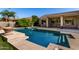 Sparkling backyard swimming pool with a tanning ledge and desert landscaping for outdoor enjoyment at 4010 E Hamblin Dr, Phoenix, AZ 85050