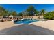 Backyard pool with blue tile, deck with outdoor kitchen featuring a grill and pizza oven with a surrounding block privacy wall at 4010 E Hamblin Dr, Phoenix, AZ 85050