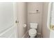 Simple powder room with tile flooring, a toilet, and a door at 4010 E Hamblin Dr, Phoenix, AZ 85050