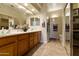 Spacious bathroom features double sinks, large mirrors, neutral tile, and walk-in shower at 4202 E Broadway Rd # 223, Mesa, AZ 85206